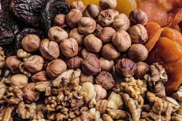 Nuts and dried fruits. Background of peeled hazelnut, walnuts kernels and dried apricots.