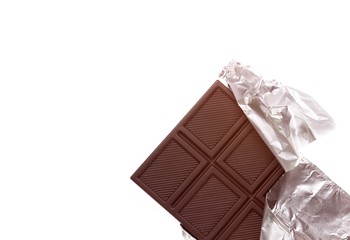 Chocolate bar wrapped in foil over white background
