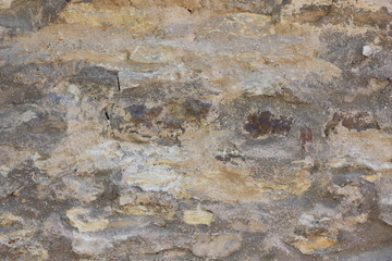Natural background, ancient wall of the medieval city, the wall of an ancient temple in Prague, stone masonry test with cement