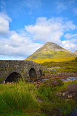 Fototapeta na wymiar Sligachan old bridge looking towards the Cuillin mountain range, Isle of Skye. Highland, Scotland, United Kingdom