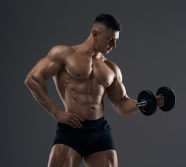 Muscular bodybuilder guy doing exercises