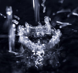 crown formed by a water spray on a black background