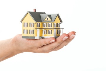Women's Hand Holding a Model of a House