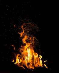 Flame of fire with sparks on a black background