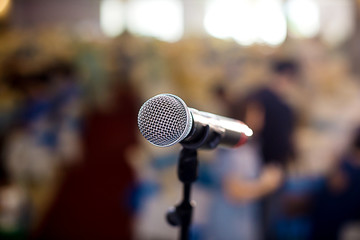 microphone in concert hall or conference room soft and blur style for background.Microphone over the Abstract blurred photo of conference hall or seminar room background.