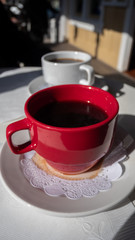 Red and White Cups with Cofee on Small Table