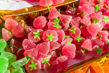 Close up of colorful dessert sweets strawberry gummy candy at a street food market