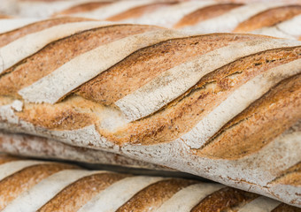 Organic freshly baked baguette bread loaves at a street food market
