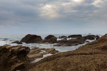 Taiwan East Coast Rocky Coastline Background Image - Overcast Skies, Exotic Rock Formations, Waves in the Ocean. Ocean Coastline, Asia Landscape Photography, Clouds reflection in background