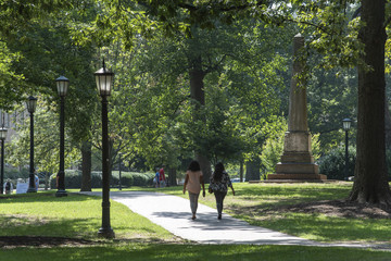 Students at UNC Chapel Hill walk around campus on a humid morning