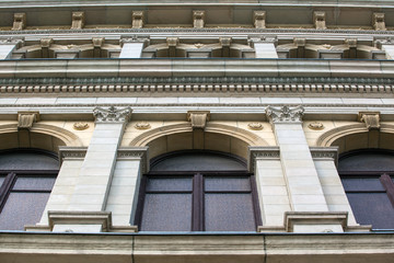 part of the wall of a beige historical building with a classic facade