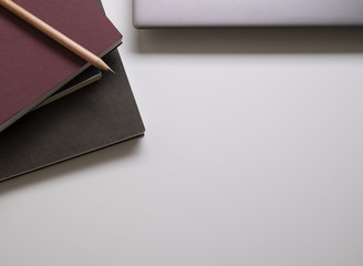 pencil on the note book and laptop on the table working space