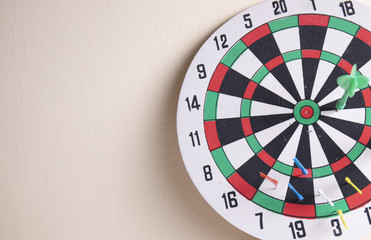 dart borad hang on the wall and red dart