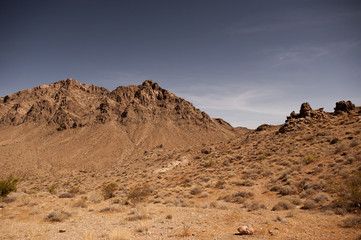 Red jagged peaks and sand with blue sky in the Valley of Fire state park