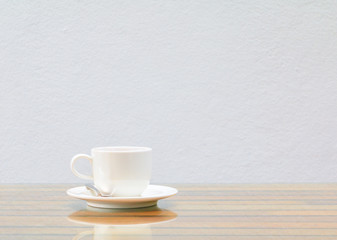 coffee cup white On the glass table wooden and a cement wall background. copy space
