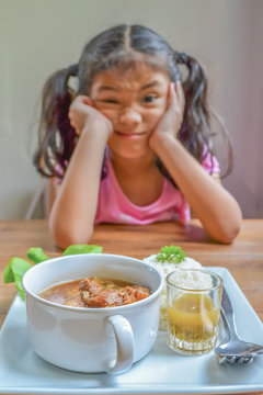 Eating disorder and appetite loss mulnutritional lifestyle in school kid little asian girl who getting bored of food refusing meal with food dislike, or no hungry eating habit