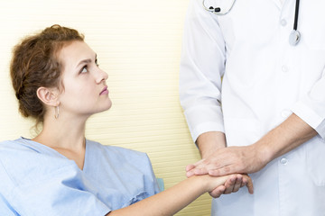 Fototapeta premium Medical professionals caucasian man reassuring and discussing with young woman worry patient.Close up and copy space.