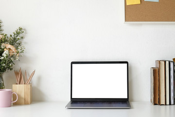 Workspace Mock up laptop and table of creative desktop of female designer with nobody. Flower...