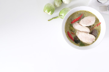 Top view Green curry soup with top view on white table and copy space.