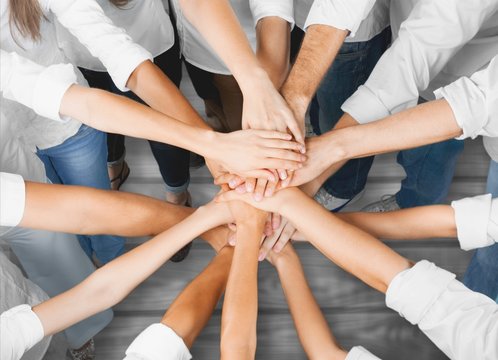Handshake of many young business people, teamwork