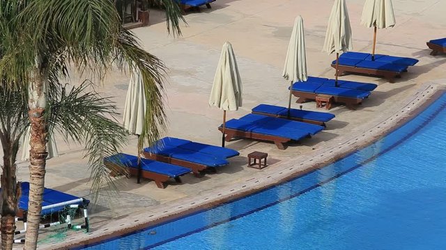 Empty swimming pool early in the morning next to the red sea in the resort hotel in Sharm El Sheikh, South Sinai, Egypt