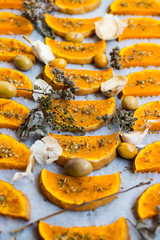 Sweet pumpkin slices grilled, roasted, backed on oven tray and parchment paper with oregano herbs, spices, garlic and olives. Vegan lunch, vegetarian vegetables dinner. Healthy organic food. 