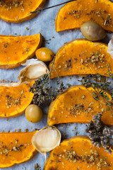 Sweet pumpkin slices grilled, roasted, backed on oven tray and parchment paper with oregano herbs, spices, garlic and olives. Vegan lunch, vegetarian vegetables dinner. Healthy organic food. 
