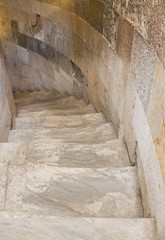 A narrow marble staircase in the leaning tower