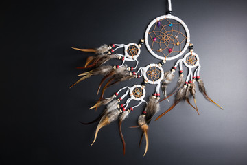 Dream catcher with feathers threads and beads rope hanging spiritual folk american native indian amulet isolated on black background.Copy space for text.Concept prevent evil in Halloween.