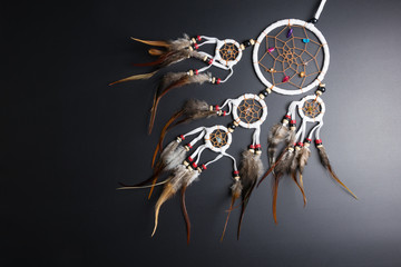 Dream catcher with feathers threads and beads rope hanging spiritual folk american native indian amulet isolated on black background.Copy space for text.Concept prevent evil in Halloween.