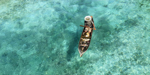 Fisherman in his boat  on turquoise sea
