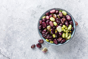 Raw organic broad beans in bowl. Healthy food. Top view.