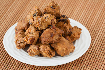 Indian pakoda snack - A macro closeup of traditional deep fried Indian snack pakkoda on a plate. A variety of nuts and flour is used to prepare it.