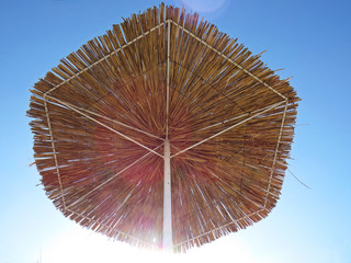 Straw Beach Parasol Umbrella Protecting from Sun During Exotic Vacation