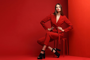 Fashion young woman in red suit. - obrazy, fototapety, plakaty