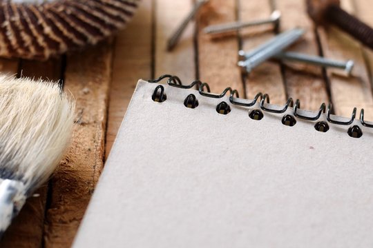 Blank Closed Up Brown Paper Copy Space On Pine Wood Pallet Background With Sand Paper, Paint Brush ,screw And Nails, DIY Home Renovation Handy  Man Father's Day Housework Concept