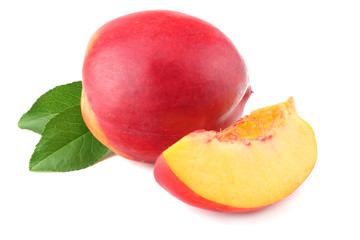 Nectarine with green leaf and slices isolated on white background.