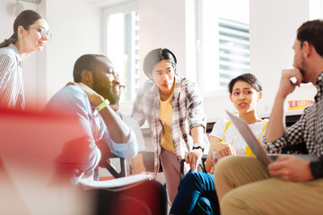 University group. Active group of smart students having a brainstorm at the university while...