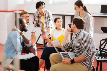 Fellow students. Smart hardworking students taking active part in their educational process and looking interested while discussing their project