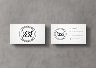 White business card stack on concrete desk 3D rendering