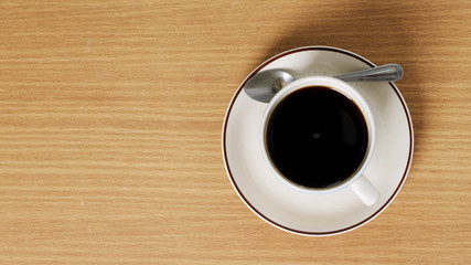 Black coffee cup on wooden table with above