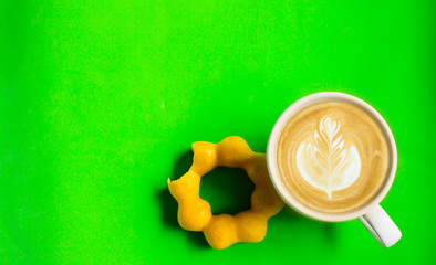 Top view, donut, chocolate, sweets and hot coffee or latteart. On a green backdrop