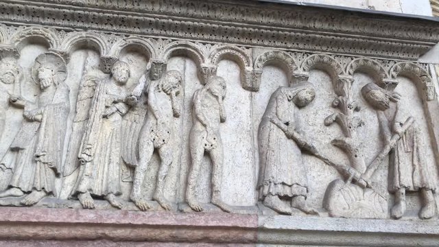 280818 Modena, Italy - sculptures on right side of Modena Duomo facade (UNESCO heritage site - Romanesque catholic church - stone Bible)