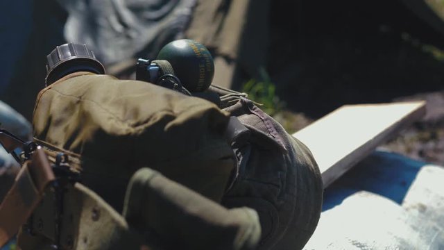 Historical Reconstruction of Vietnam War. Hand grenade from the equipment of the American soldier. Base camp footage. 