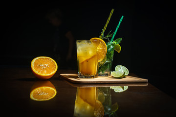 Fresh cocktail on a black background. Alcoholic cocktail on a black background. Fruit with a cocktail. Non-alcoholic cocktail. Mix of cocktails on a black background. 