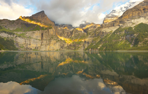 Mountain landscape with a lake of Oeschinensee during a sunset, Switzerland