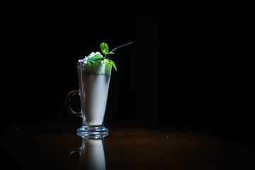 Coffee drinks on a black background. Coffee on a black table. Cold coffee. Latte. Cappuccino. Espresso. Coffee cocktails. Milkshakes. Whipped cream. Barista