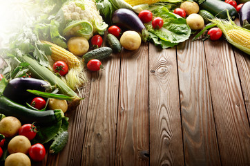 Fototapeta na wymiar Fresh Organic Vegetable Food Ingredients on Wooden kitchen table background. Space for text.