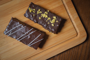 Piece of cake on a wooden board. Brownie. It's cake. Cake on a plate. A piece of cake on a plate with coffee.