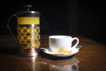 Tea on a black background. Fruit tea. Cold tea. Teapot with tea.